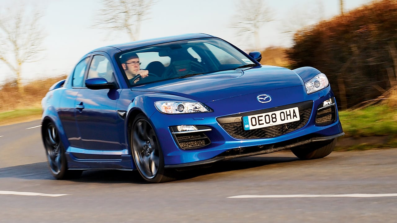 A blue Mazda driving along the road after implementing cloud discovery processes on the ServiceNow platform.